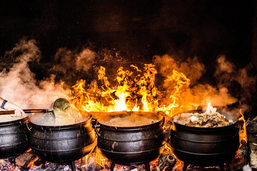 time lapse photography of four black metal cooking wares